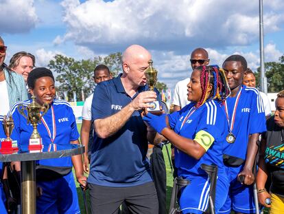 FIFA president Gianni Infantino presents a trophy to the members of the Nyarugenge women's Amputee Football team after their win over Musanze women's amputee football team, after the launch of the women's Amputee Football championship in Rwanda, at the Pele Stadium, in Kigali, Rwanda March 16, 2023.