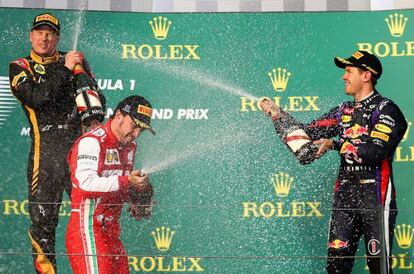 Kimi Raikkonen (l), Fernando Alonso (c) and Sebastian Vettel (r) celebrate on the podium after the Australian Grand Prix on Sunday.