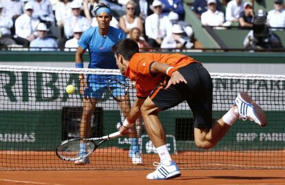 Djokovic devuelve una pelota ante Nadal.