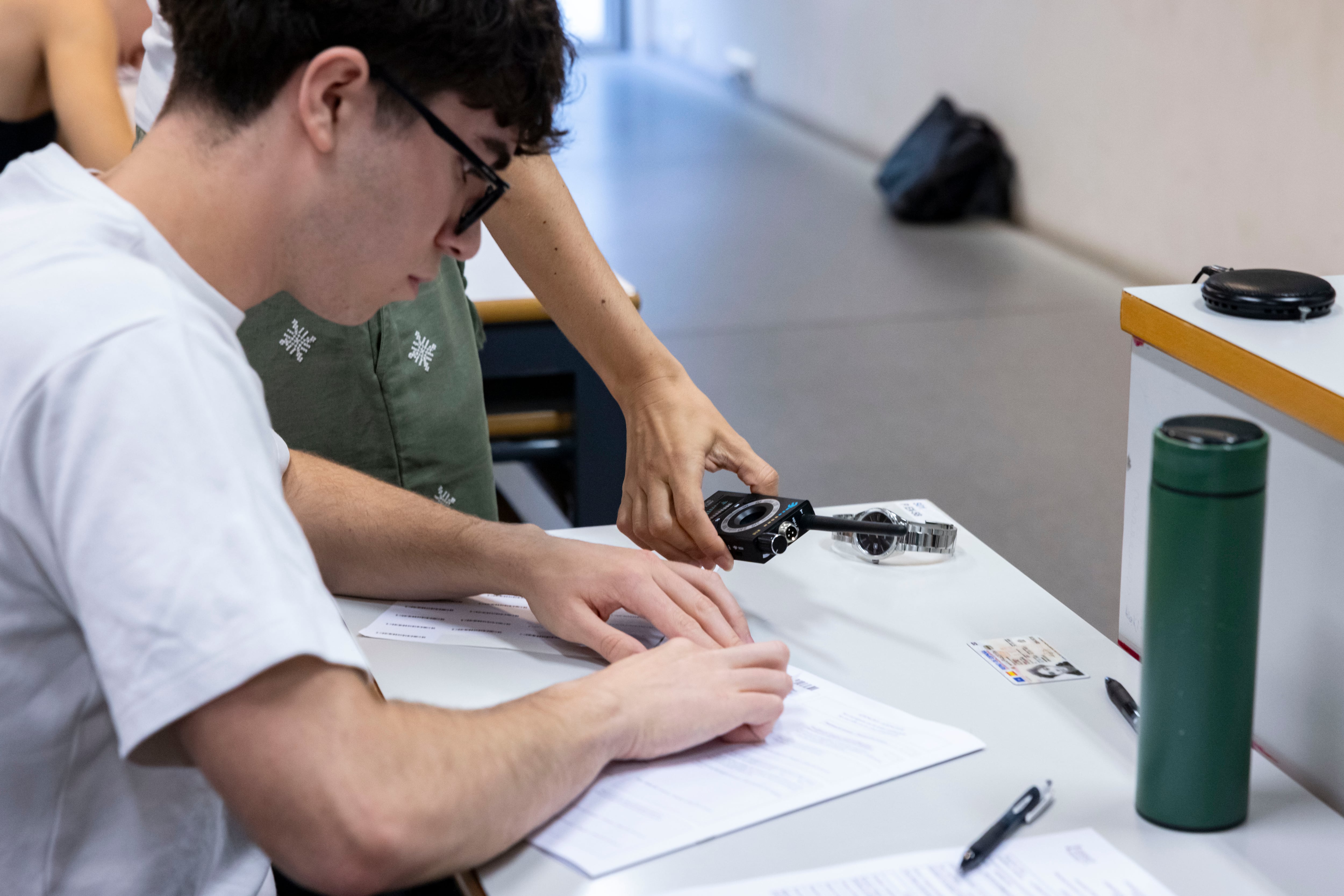 Una examinadora utiliza un detector de señales durante las Pruebas de Acceso a la Universidad (PAU) que comienzan este martes en la Comunitat Valenciana.