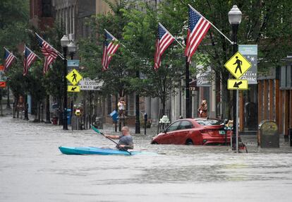 A kayaker paddles across Main Street in downtown Barre, Vt., on Monday night, July 10, 2023.