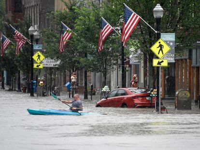 A kayaker paddles across Main Street in downtown Barre, Vt., on Monday night, July 10, 2023.