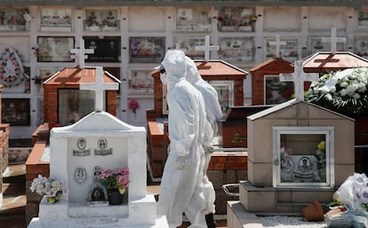 Trabalhadores puxam o caixão durante o sepultamento de uma vítima da covid-19, em um cemitério de Porto Alegre.