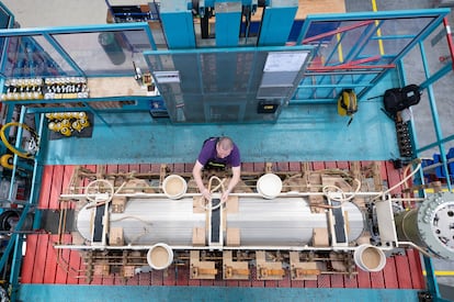 An operator works at a Siemens transformer factory in Dresden, Germany, in April 2023.