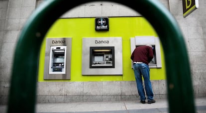 Un hombre utiliza una cajero de Bankia