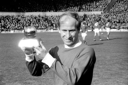 Manchester United's Bobby Charlton lifts the 1966 European Footballer of the Year trophy.