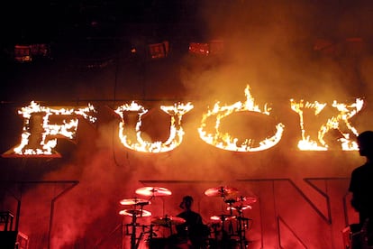 Blink-182 playing in California’s Long Beach Arena against a background of the word ‘fuck’ lit in flames.
