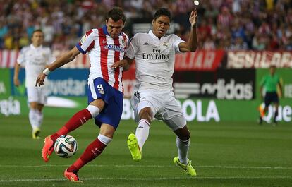 Mandzukic dispara ante Varane para conseguir el gol de la victoria (1-0) del Atlético en el partido de vuelta de la Supercopa de España