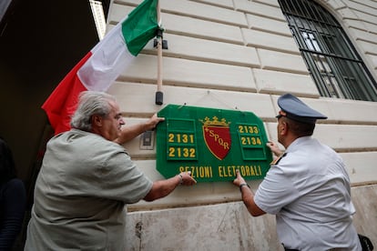 Dos hombres preparando una de las oficinas de votación de Roma para la elección de este domingo. 
