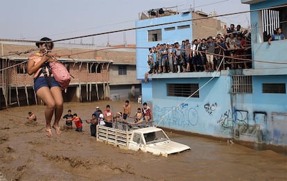 Peru’s national weather agency (Senamhi) has forecast more heavy rains in coming days. Here, a woman is evacuated in Peru on March 17.