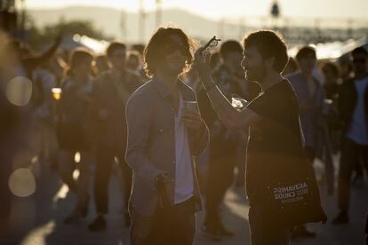 Dos joves conversen mentre es prenen una cervesa al recinte dels concerts del Primavera Sound 2016.