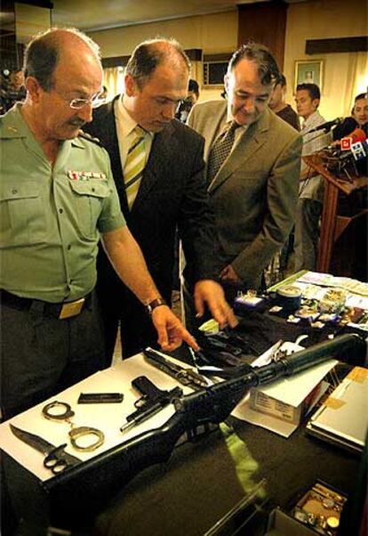 El coronel de la Guardia Civil Joaquín Borrell, junto al delegado del Gobierno, Antoni Bernabé (centro), inspeccionan el material intervenido.