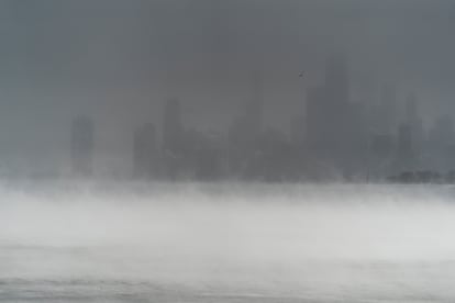 The buildings of downtown Chicago, blurred behind the snow and steam of Lake Michigan, as seen from Montrose, December 23.
