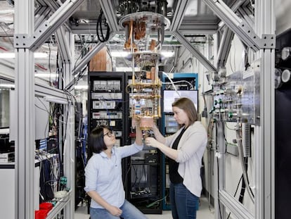 Two IBM researchers prepare a model of a quantum computer at the company's U.S. headquarters in January.