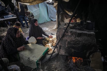 Displaced Gaza women cook at a UN school in the southern Strip, February 24, 2024.