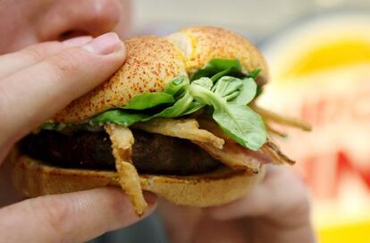 Una persona consume una hamburguesa de carne de caballo.