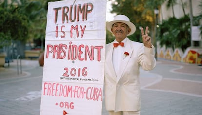 A Cuban American poses with a poster backing Donald Trump on Little Havana’s Calle Ocho.