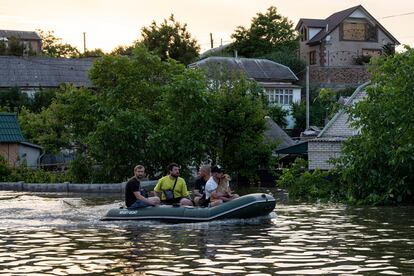 Volunteers evacuate a dog from a flooded neighborhood in Kherson on June 7.
