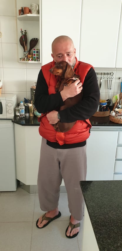 Felipe Turover hugging Pippa, the Freijo Lloyd family's dog.