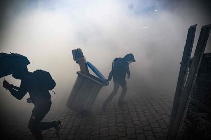 Protestors clash with police officers during a demonstration in Nantes, western France, on April 13, 2023.