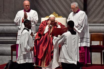 Pope Francis prepares to read as he presides over the Passion of the Lord mass on Good Friday at St. Peter's basilica in The Vatican