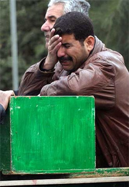 Un hombre llora sobre el féretro de una víctima del atentado de Bagdad.