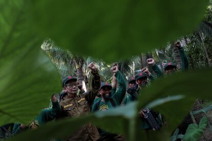 SIERRA MADRE - NOVEMBER 23, 2016: New Peoples Army guerillas raised their clenched fists during a photo session after program inside their camp on November 23, 2016 in Sierra Madre, Philippines. The New People's Army, the military organization of the communist movement in the Philippines, had warned of a possible failure of the ongoing peace talks with the Duterte government during a meeting with reporters on Wednesday, if the U.S. and Philippine treaty alliance continues. Tucked in the encampment of Sierra Madre mountains southeast of Manila, the Communist guerrillas have been waging a half century war against the U.S. treaty alliance with the Philippines, resisting against its military presence and trade freedom. The NPA also warned against making allies with countries like China and Russia who are also imperialists in nature, they said. (Photo by Jes Aznar/Getty Images)