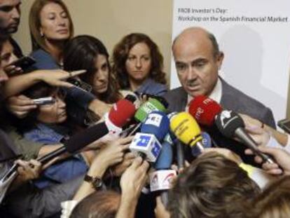 El ministro de Economía, Luis de Guindos, atiende a los medios tras clausurar una jornada de trabajo organizada por el Fondo de Reestructuración Ordenada Bancaria (FROB) sobre el sistema financiero español, dirigida a inversores internacionales que se ha celebrado hoy en Madrid.