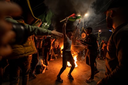 Palestinians celebrate the announcement of a cease-fire after five days of fighting between Israel and the Islamic Jihad militant group in Gaza City, Saturday, May 13, 2023.