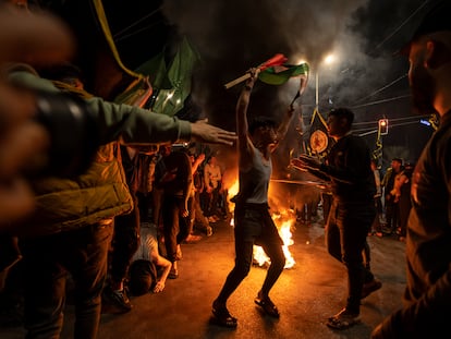 Palestinians celebrate the announcement of a cease-fire after five days of fighting between Israel and the Islamic Jihad militant group in Gaza City, Saturday, May 13, 2023.