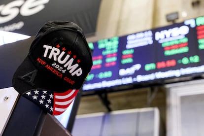 Un gorra de apoyo a Trump ante los carteles de la Bolsa de Nueva York.