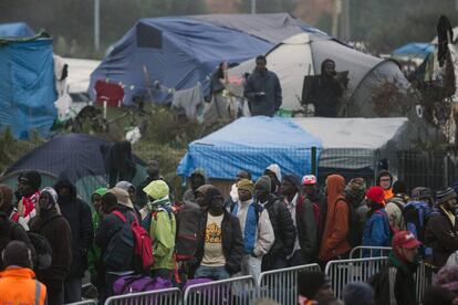Migrantes esperan su turno para ser registrados en el campamento de Calais (Francia).