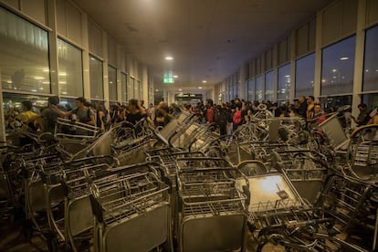 Protesters blocked the entrance with luggage carts.