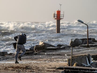 A person struggles against the wind at Thorsminde Harbour, in the west coast of Jutland, Denmark, 21 December 2023.
