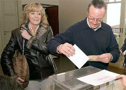 El presidente del PP de Cataluña, Josep Piqué, acompañado por su esposa, deposita su voto en una de las urnas instaladas en el Instituto de Estudios Superiores de Empresa de Barcelona.