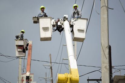 Puerto Rico Electric Power Authority workers repair distribution lines damaged by Hurricane Maria in the Cantera community of San Juan, Puerto Rico, Oct. 19, 2017.