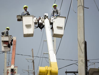 Puerto Rico Electric Power Authority workers repair distribution lines damaged by Hurricane Maria in the Cantera community of San Juan, Puerto Rico, Oct. 19, 2017.
