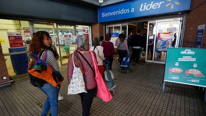 Un grupo de personas hace fila para entrar a un supermercado, en Santiago, en una imagen de archivo.