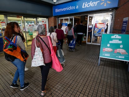 Un grupo de personas hace fila para entrar a un supermercado, en Santiago, en una imagen de archivo.