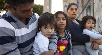 Juana Amador con sus hijos y su marido ante el polideportivo Ciudad Jard&iacute;n de Alicante en el que se encuentran alojados.
