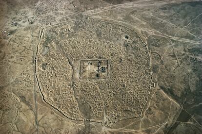 <p>La ciudad oasis de Hatra, en el norte de Irak, siglos II-III. Es patrimonio de la humanidad por la Unesco. Fue ubicada en medio del desierto, rodeada por un muro, como enclave operativo de una importante ruta de caravanas. </p><br><b>Murallas desde el cielo</b><br>Hubo que esperar hasta el siglo XX para que las murallas de la mayoría de las ciudades desapareciesen o se convirtiesen en imponentes monumentos históricos. París, por ejemplo, perdió definitivamente las suyas en 1929. Roma, en cambio, conserva todavía la que el emperador Aureliano mandó construir en el siglo III para hacer frente a las invasiones bárbaras. En muchos casos marcan todavía el perímetro de lo que se considera el centro histórico. Desde luego, las primeras ciudades estaban protegidas primero por empalizadas y posteriormente por sólidos muros de piedra. Era su cometido: dar seguridad. Y aunque el tiempo las haya borrado, siguen estando ahí, visibles sobre todo desde el cielo. Estas imágenes del suizo Georg Gerster, fallecido en febrero a los 90 años, muestran cómo desde arriba las construcciones de todas las civilizaciones se parecen, cómo la humanidad encontró soluciones similares a problemas que se repetían por todo el planeta. Y el primero de ellos, en la Antigüedad, era la protección de sus habitantes. Gester fue el gran pionero de la fotografía aérea, el primero que ensayó un punto de vista diferente que ahora está en plena eclosión con los drones.</p> <p><br> Texto de Guillermo Altares</p>