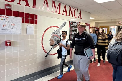 Students walk past a logo that is tiled into the wall at Salamanca High School in Salamanca, N.Y., on April 18, 2023.