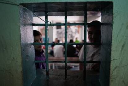 Two inmates talk in the canteen.