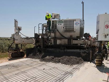 Una m&aacute;quina de la constructora Sando extiende hormig&oacute;n durante las obras de la variante de Marchena (Sevilla).