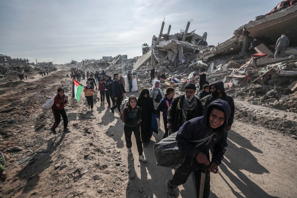 Palestinians walk through the destruction caused by the Israeli air and ground offensive in Jabaliya, as a ceasefire deal between Israel and Hamas went into effect, Sunday, Jan. 19, 2025. (AP Photo/Abed Hajjar) 


Associated Press / LaPresse
Only italy and Spain