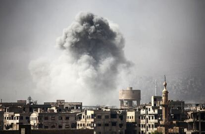 Humo de un incendio en los edificios tras un ataque aéreo en Ghouta, bastión rebelde en Siria.