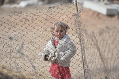 Una niña desplazada que ha huído del Estado Islámico mira tras una valla en Hashid Shaabi, el campo de refugiados del oeste de Mosul (Irak).