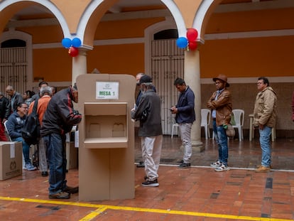 Ciudadanos esperan en fila para emitir su voto en el Colegio Mayor de San Bartolomé, en Bogotá, este domingo.