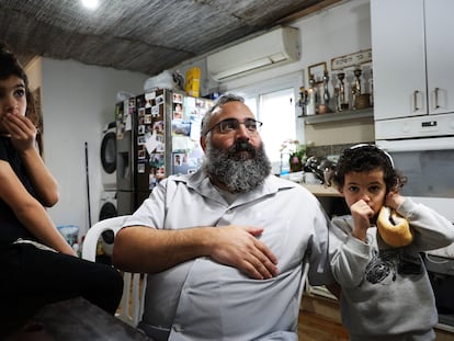Yehuda Shimon, 49, with two of his 10 children at his home in the illegal settlement of Havat Gilad (West Bank).