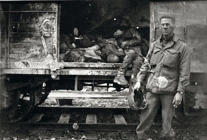 American soldier before a train loaded with dead inmates, shortly after the liberation of Dachau.  They had left Buchenwald about three weeks earlier.